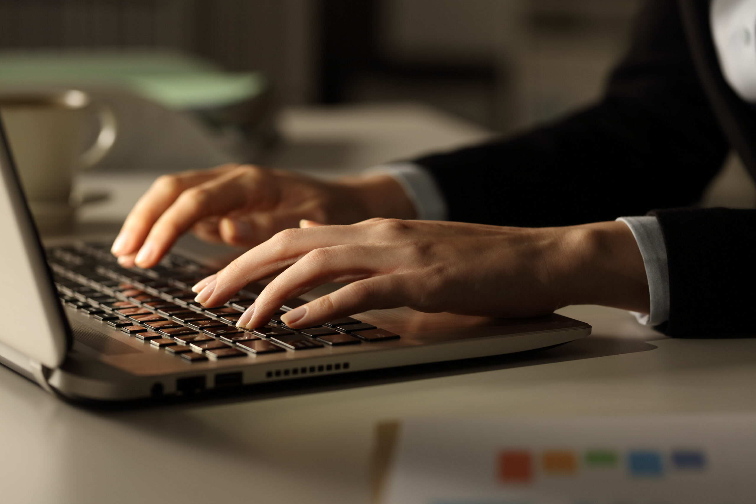 Business woman hands typing on laptop at night Business woman hands typing on laptop at night